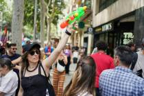 A protester with a water gun takes part in a protest against overtourism in Barcelona, Spain, S ...