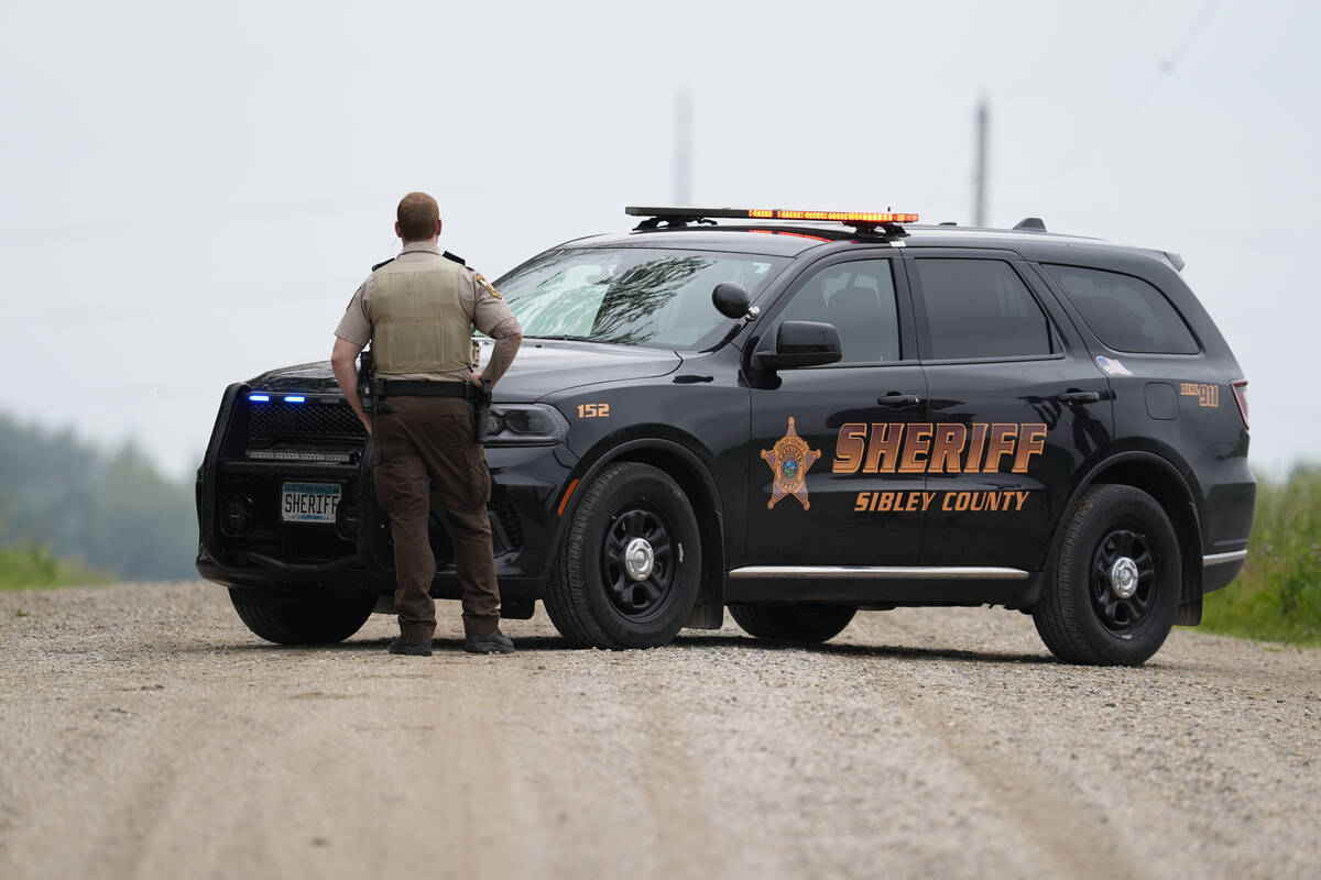 A Sibley County Sheriff's Deputy blocks the road where the suspect involved in the shooting of ...