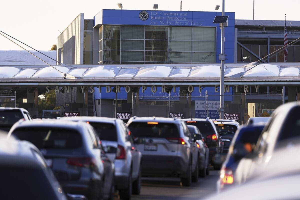 Vehicles wait in line to cross the border into the United States at the San Ysidro Port of Entr ...