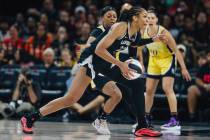 Aces center A'ja Wilson (22) dribbles the ball during a WNBA basketball game between the Aces a ...
