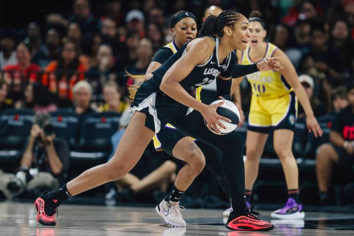 Aces center A'ja Wilson (22) dribbles the ball during a WNBA basketball game between the Aces a ...