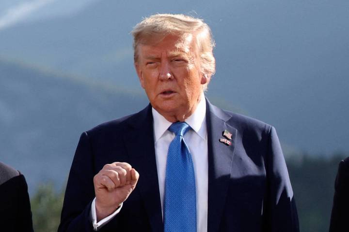 U.S. President Donald Trump gestures as he attends a family photo session during the G7 Summit, ...