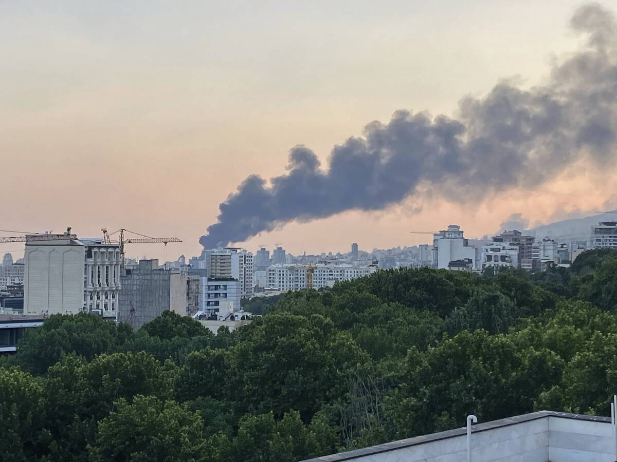 Smoke rises from the building of Iran's state-run television after an Israeli strike in Tehran, ...