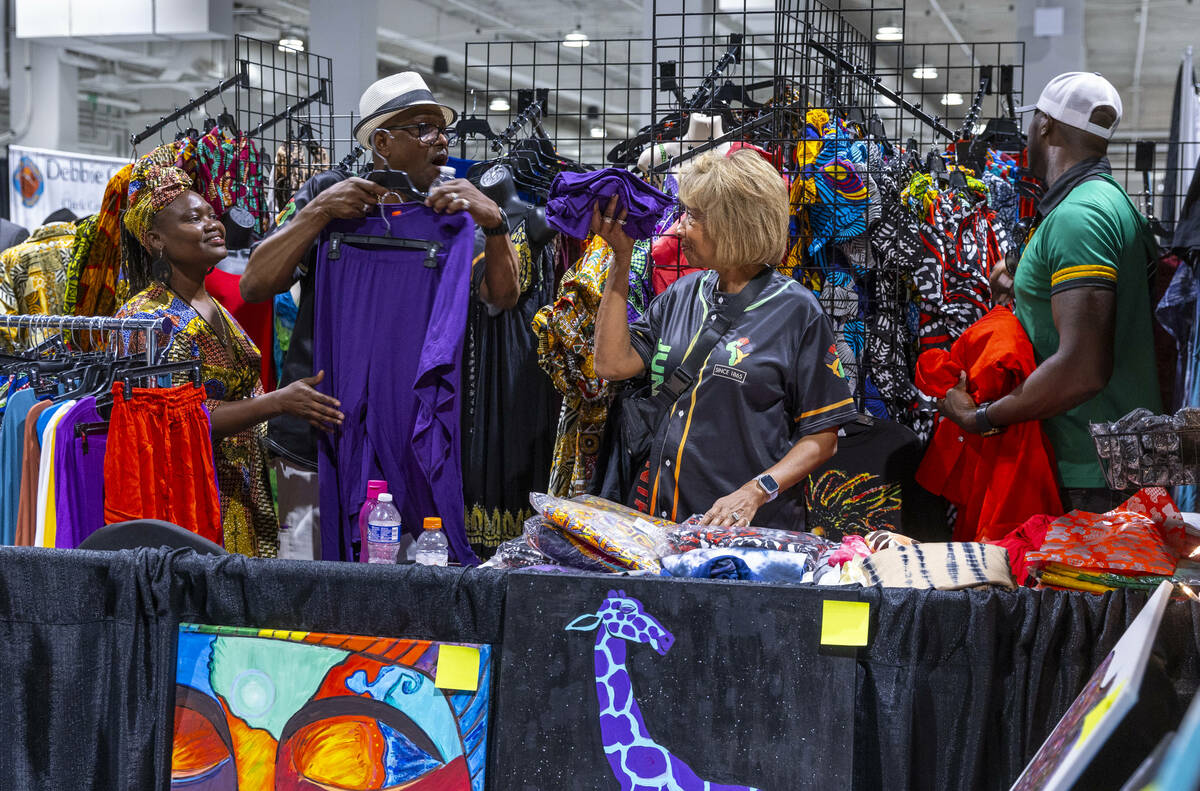 Mayor of North Las Vegas Pamela A. Goynes-Brown, center, shows off an item she likes to husband ...