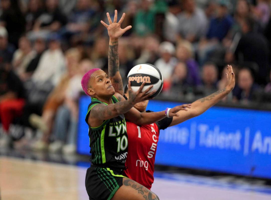 Minnesota Lynx guard Courtney Williams goes up for a shot against Las Vegas Aces' Kierstan Bell ...
