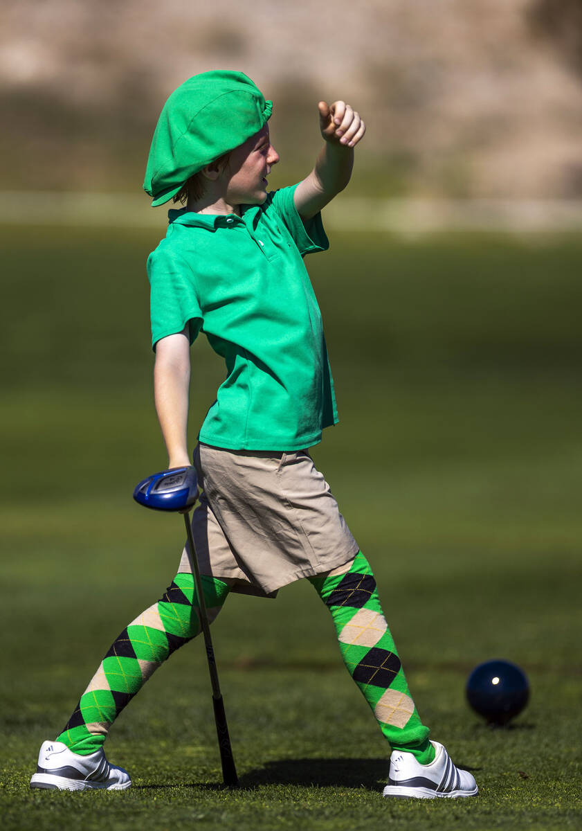 Alexandros Kheel, 9, employs some body English to will his drive farther during qualifying for ...