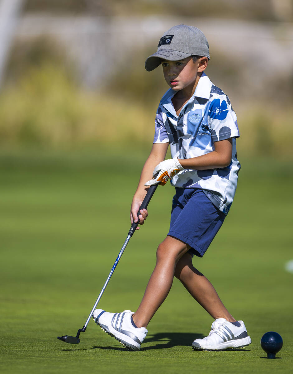 Cash Carpenter employs some body English as he eyes his putt headed to the pin during qualifyin ...