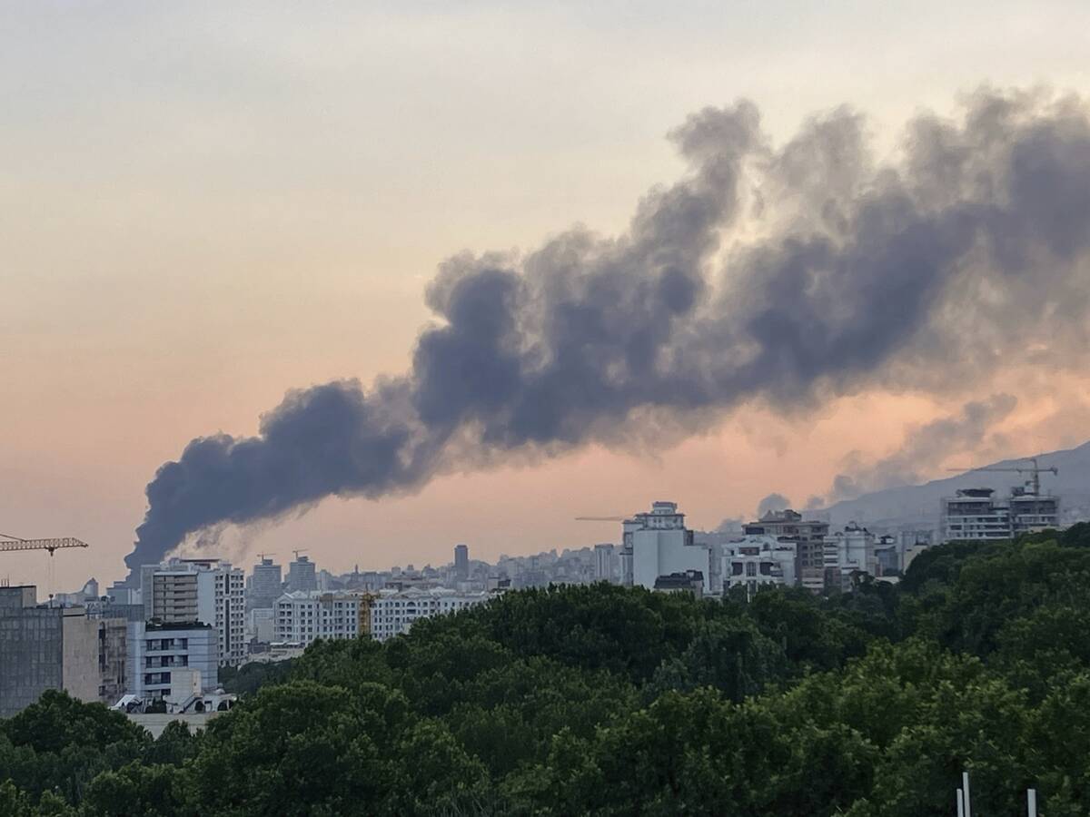 Smoke rises from the building of Iran's state-run television after an Israeli strike in Tehran, ...
