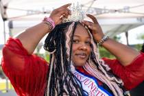 Zhararah Johnson, second runner-up for Miss Juneteenth Nevada, adjusts her crown before a flag ...