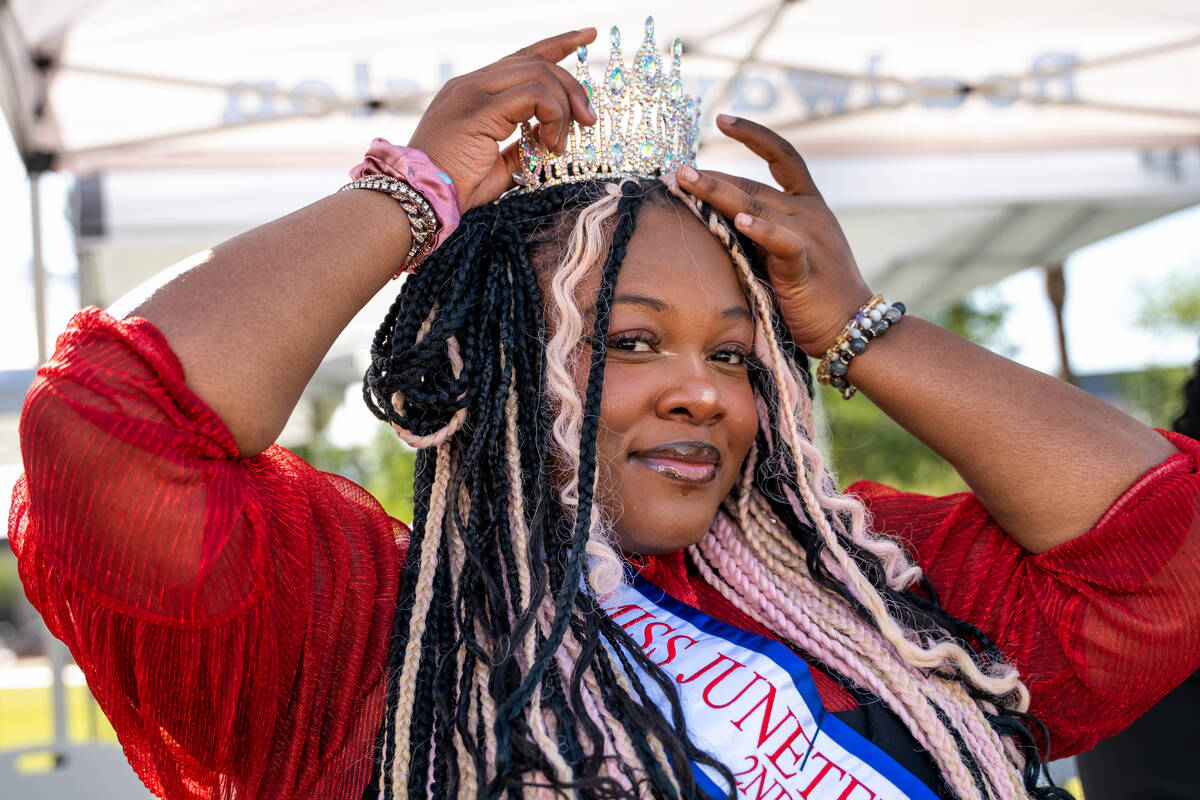 Zhaharah Johnson, second runner-up for Miss Juneteenth Nevada, adjusts her crown before a flag ...