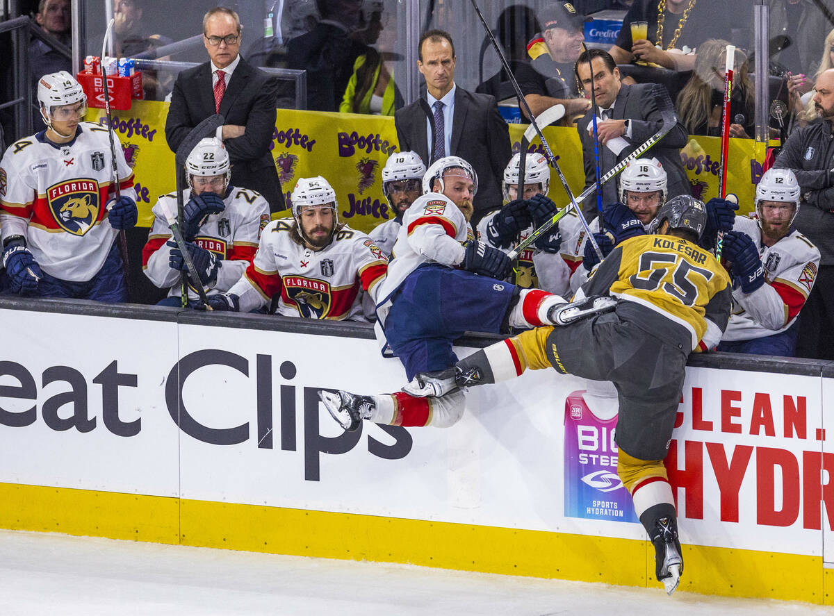 Florida Panthers defenseman Aaron Ekblad (5) is knocked into the bench by Golden Knights right ...