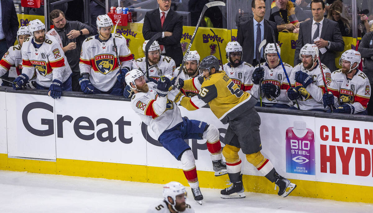 Florida Panthers defenseman Aaron Ekblad (5) is knocked off his skates by Golden Knights right ...