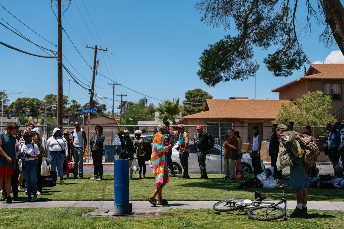Shirley Raines, center, organizes the line of people awaiting a home-cooked meal at Tonopah Par ...