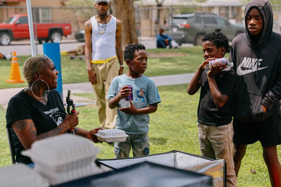 Shirley Raines offers food and beverages to kids in Tonopah Park on Sunday, June 1, 2025, in No ...