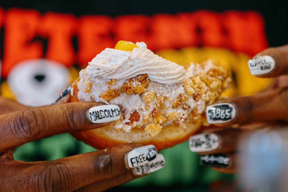 Shirley Raines samples her signature peach cobbler doughnut on Thursday, June 19, 2025, at Sain ...