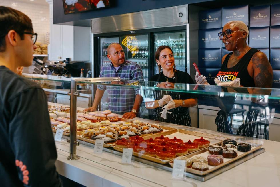 Saint Honoré co-owners Steve Jerome and Alexandra Lourdes listen as Shirley Raines explain ...