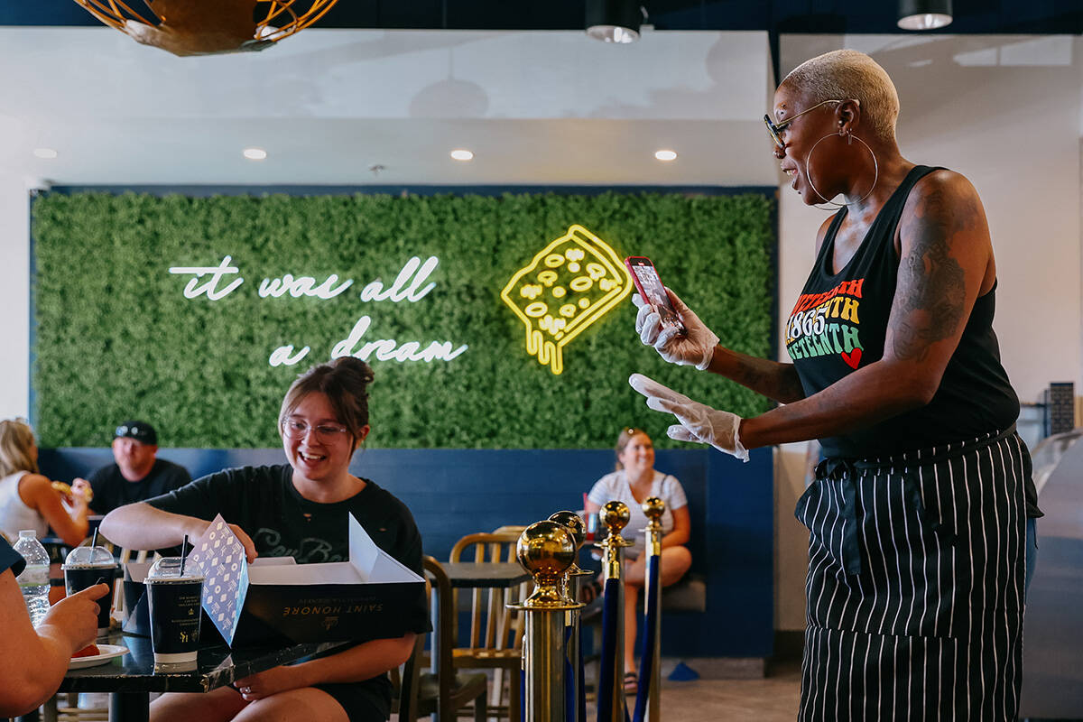Shirley Raines interacts with patrons of Saint Honoré after they bought her signature peach co ...