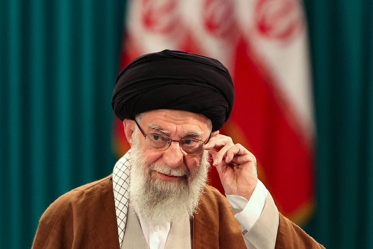 Iran's Supreme Leader Ayatollah Ali Khamenei adjusts his eyeglasses during a news conference af ...