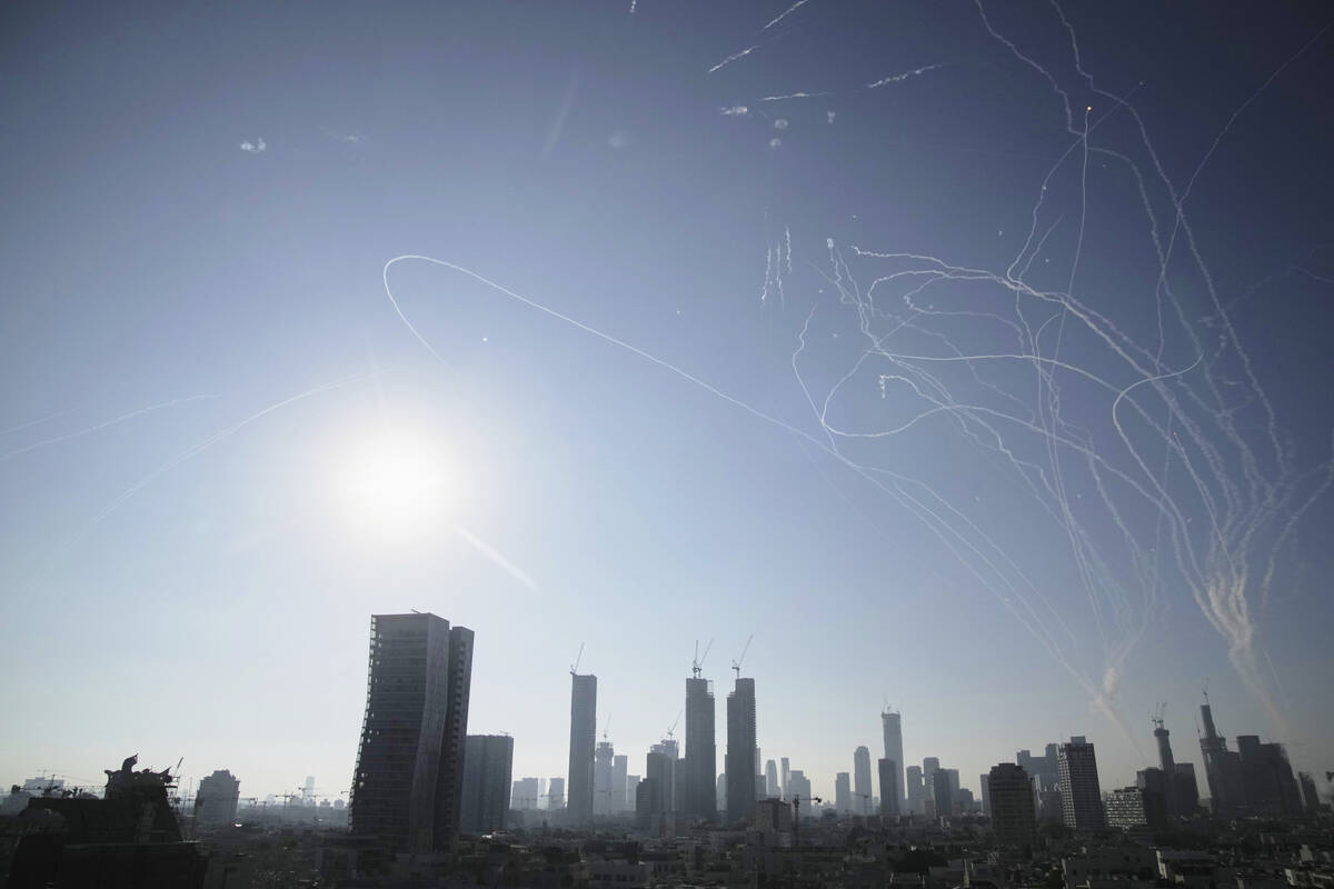Israeli air defense system fires to intercept missiles during an Iranian attack over Tel Aviv, ...