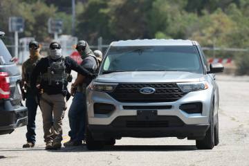 ICE agents stage outside Gate E of Dodger Stadium on Thursday, June 19, 2025. Sporadic immigrat ...