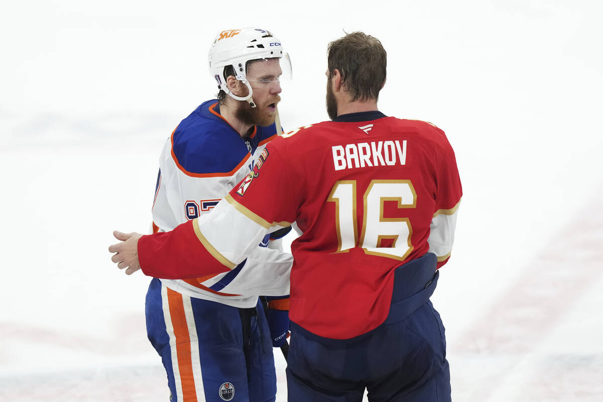 Edmonton Oilers' Connor McDavid (97) congratulates Florida Panthers' Aleksander Barkov (16) aft ...