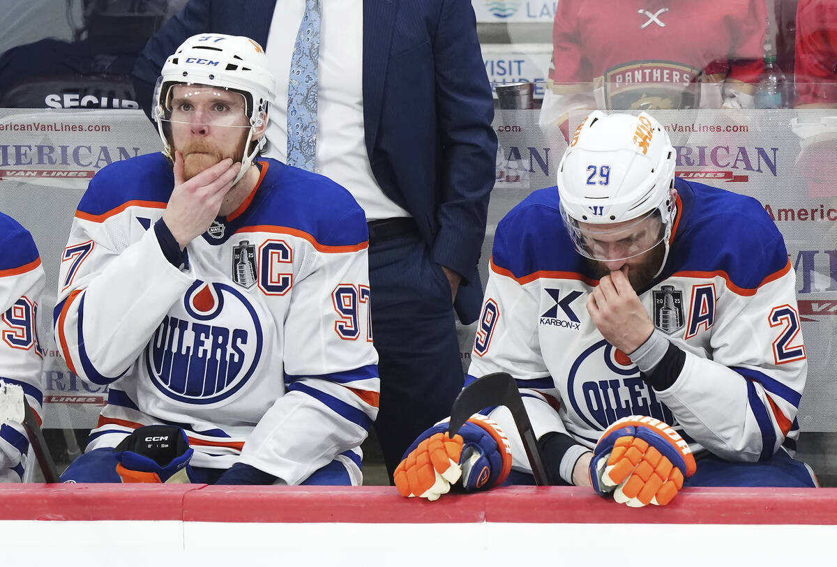 Edmonton Oilers' Connor McDavid (97) and Leon Draisaitl (29) react to a Florida Panthers empty ...