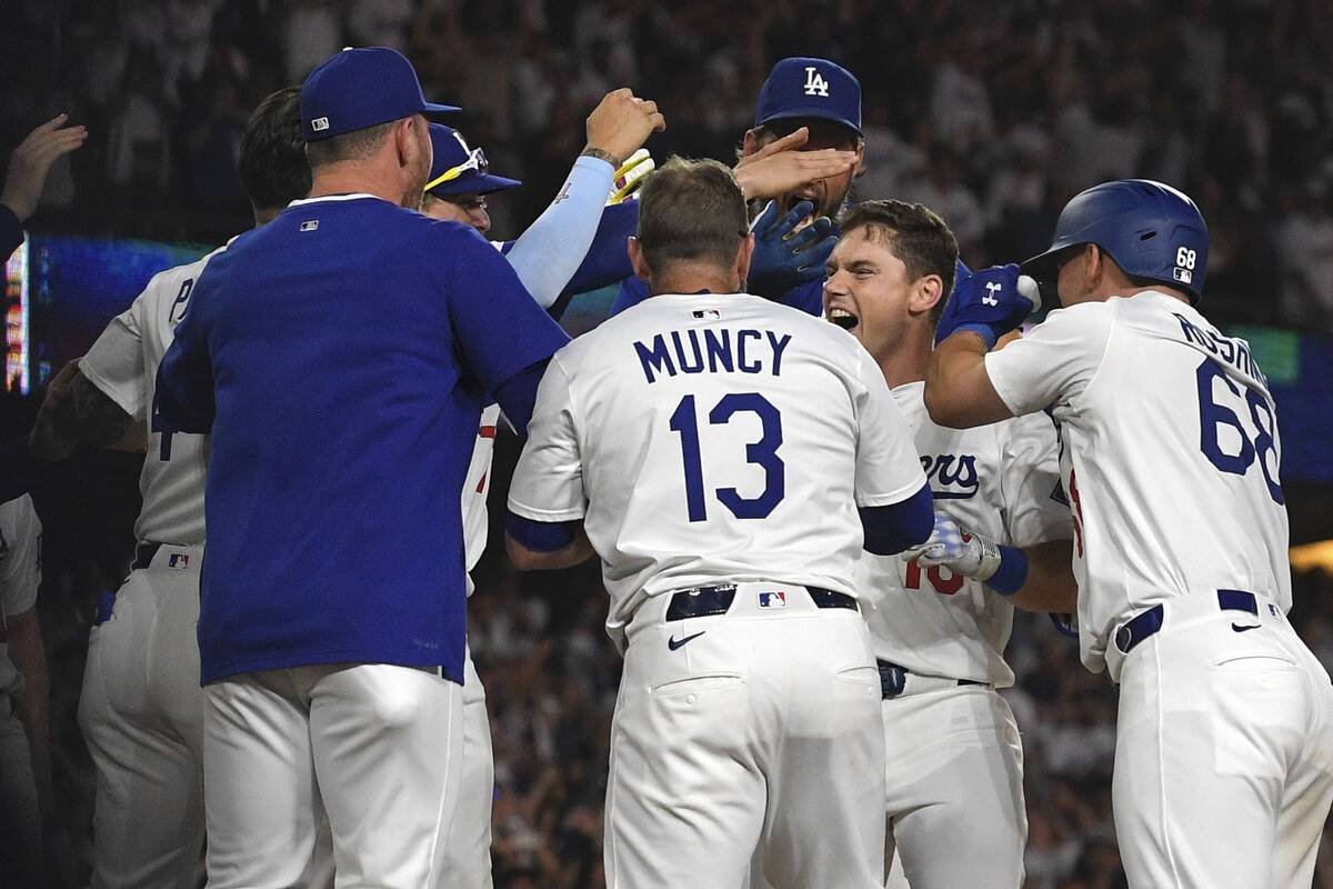 Los Angeles Dodgers' Will Smith, second from right, celebrates with teammates after hitting a w ...
