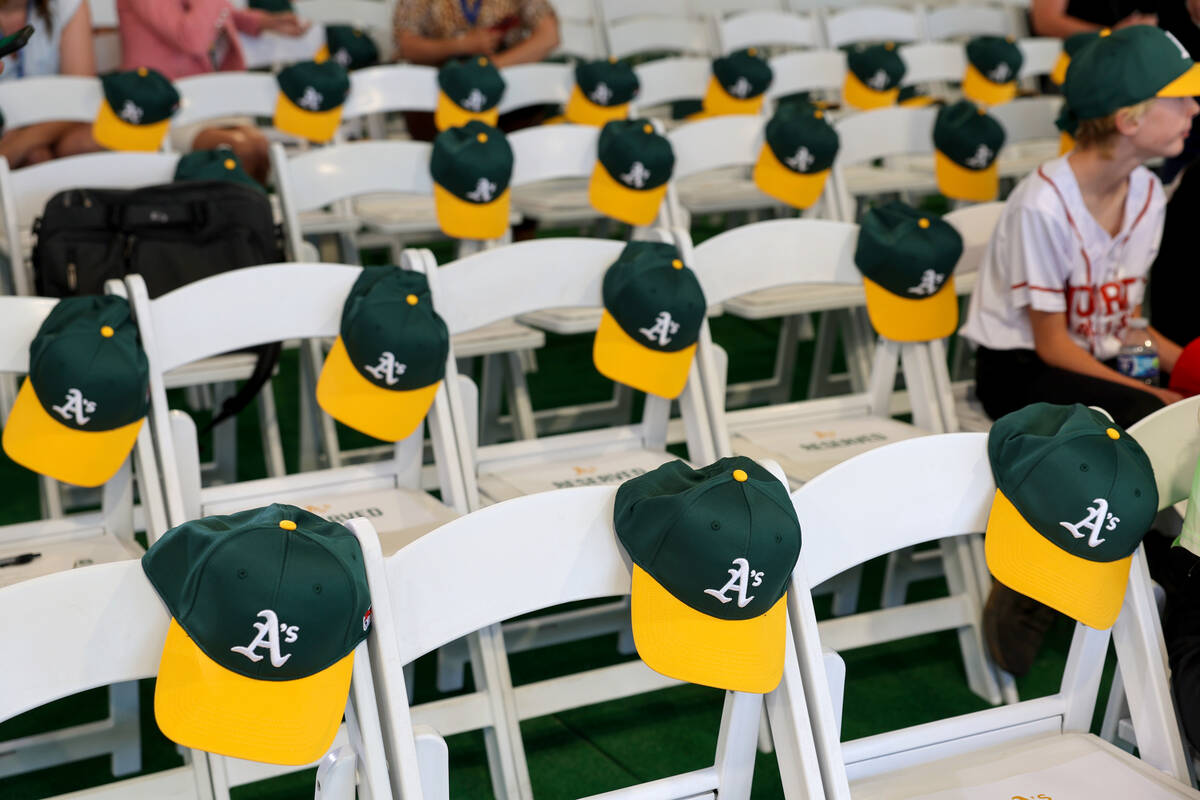 Gift hats for guests hang on chairs during a groundbreaking ceremony for the Athletics' $1.75 b ...