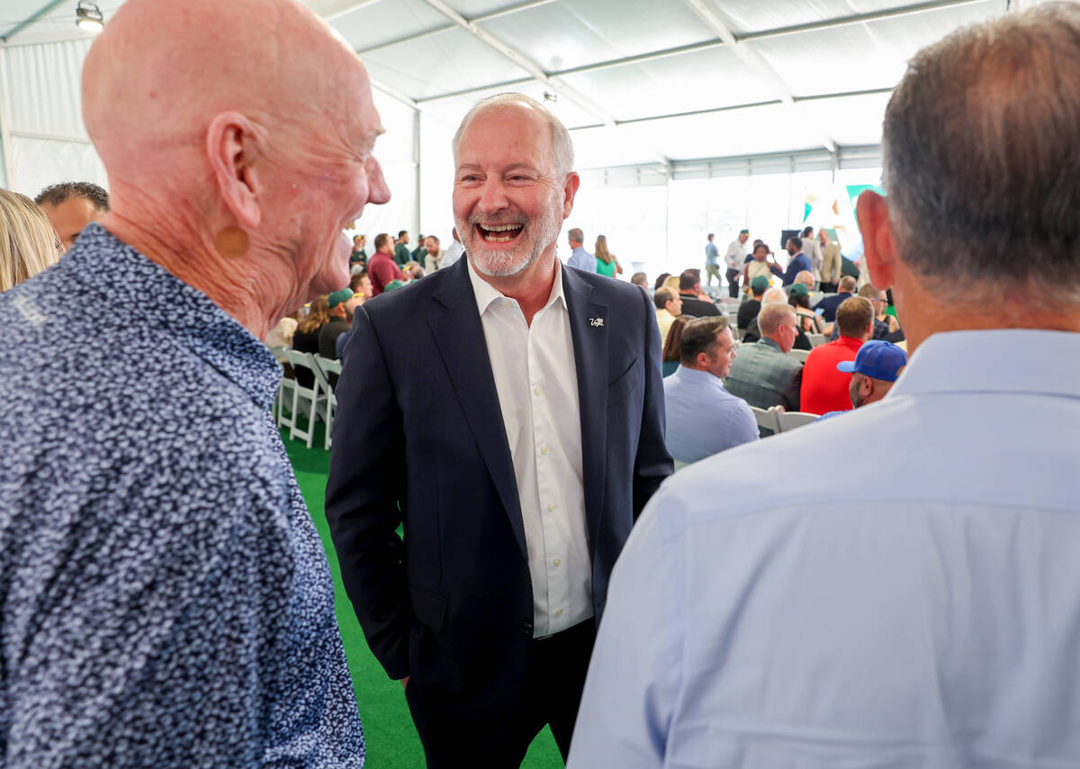 Las Vegas Convention and Visitors Authority President and CEO Steve Hill, center, visits with f ...