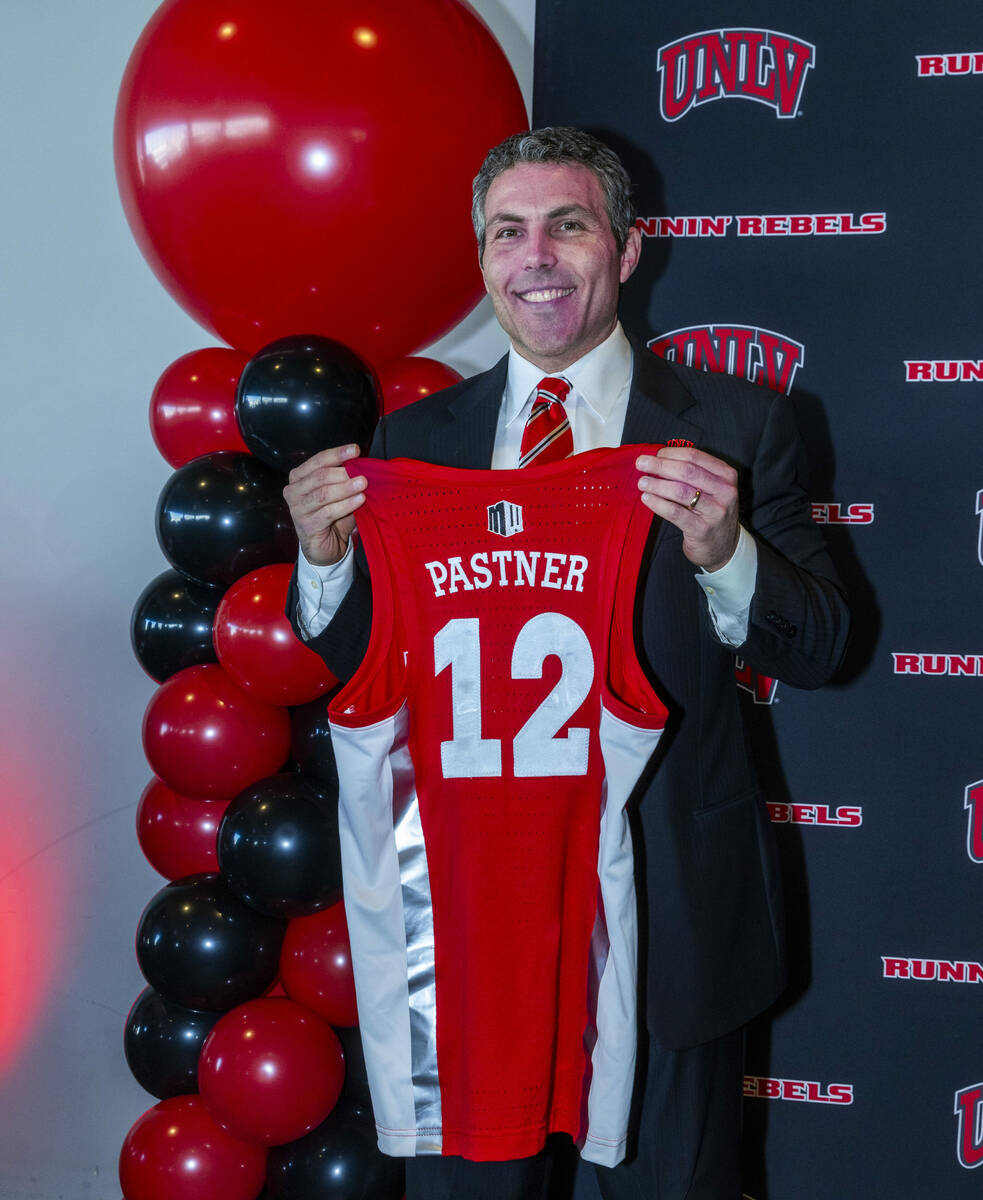 UNLV new men's basketball coach Josh Pastner shows off his custom jersey during and introductor ...