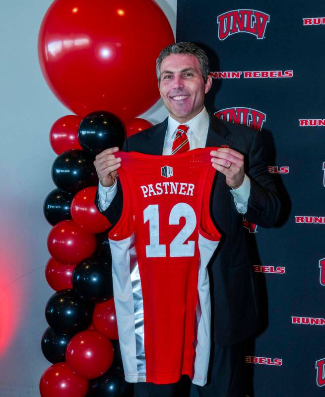UNLV new men's basketball coach Josh Pastner shows off his custom jersey during and introductor ...