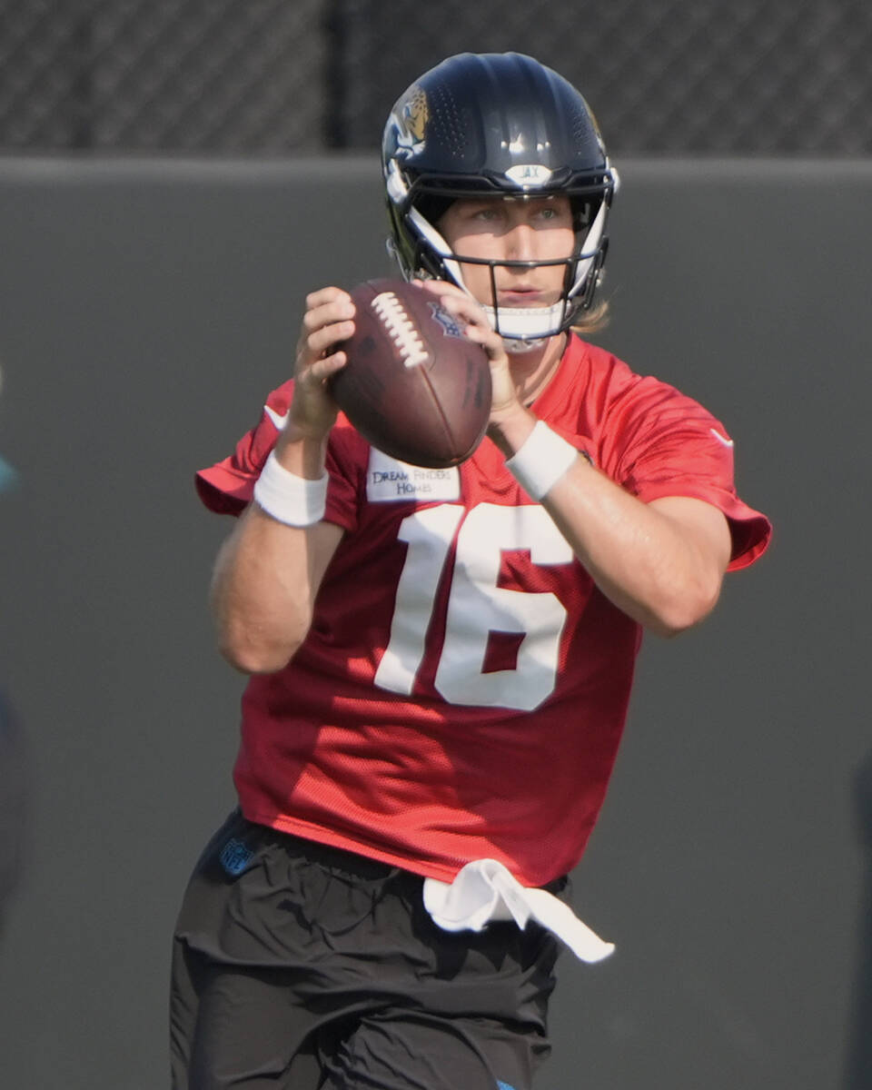Jacksonville Jaguars quarterback Trevor Lawrence (16) performs a passing drill during a team NF ...