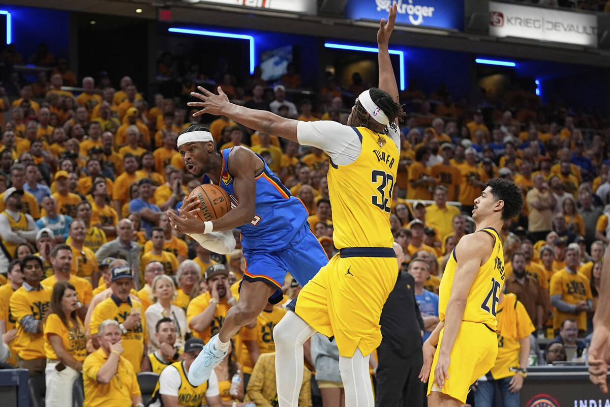 Oklahoma City Thunder guard Shai Gilgeous-Alexander is fouled by Indiana Pacers center Myles Tu ...