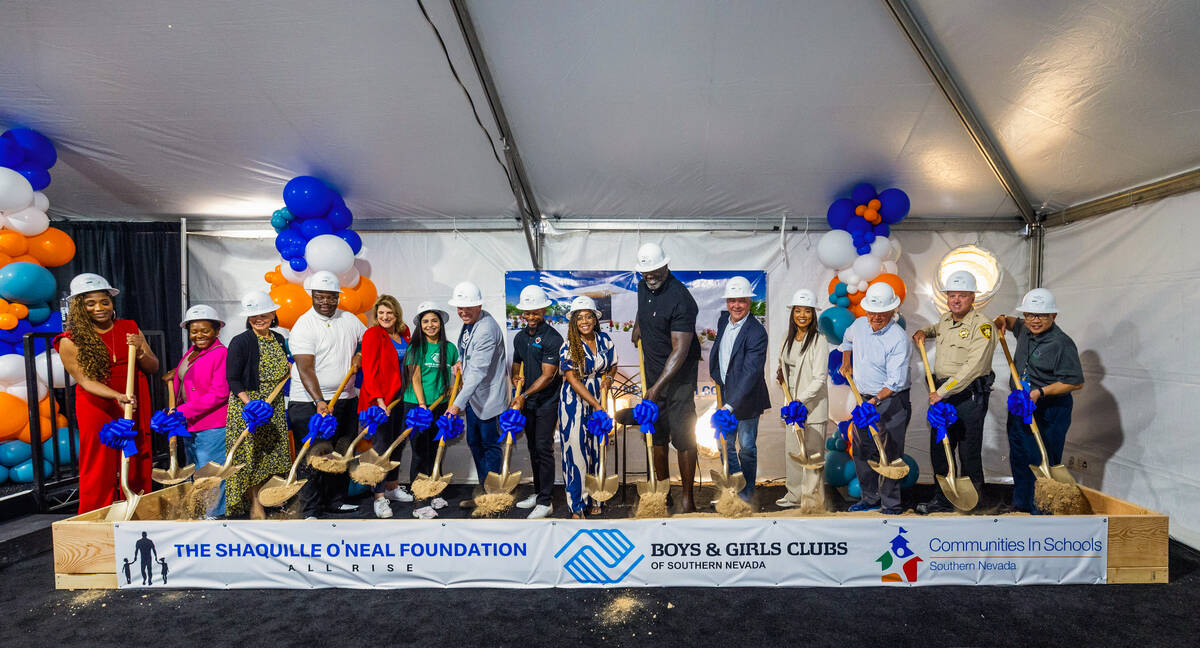 Shaquille O’Neal, joined by local leaders and dignitaries, toss their shovels of dirt du ...