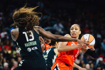 Seattle Storm forward Ezi Magbegor (13) guards Aces center A'ja Wilson (22) during a WNBA baske ...