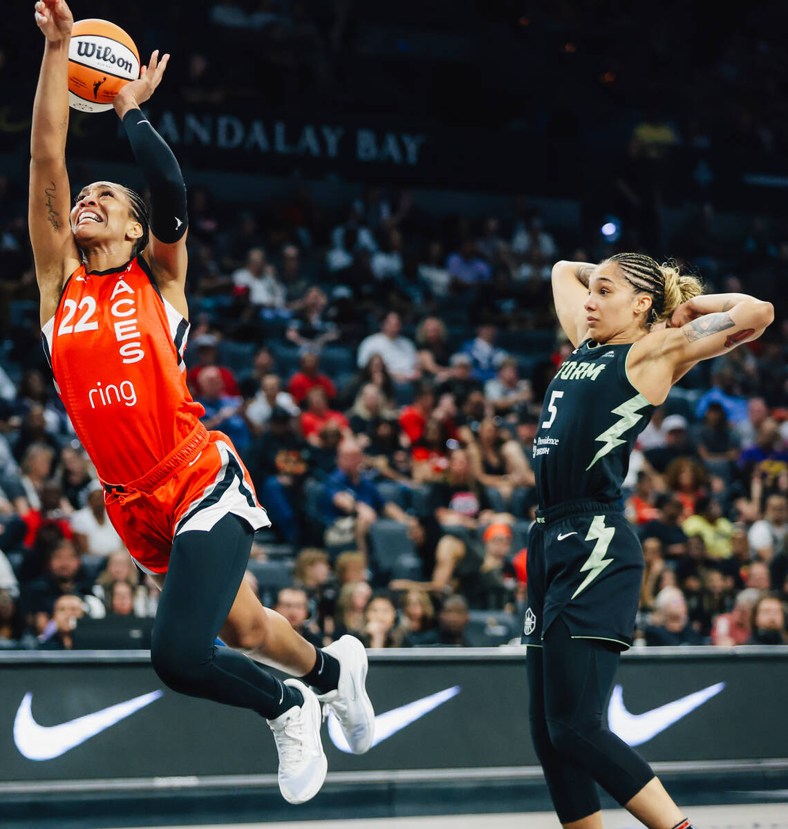 Aces center A'ja Wilson (22) leaps forward for a basket as Seattle Storm forward Gabby Williams ...