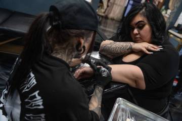 Cindy Angulo works on a tattoo for Elizabeth Sanchez during a fundraiser at Lost Souls Tattoo S ...