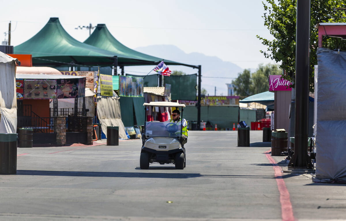 A security guard patrols the vacant Broadacres Marketplace in North Las Vegas, which was closed ...