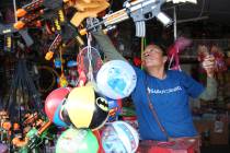 Irene Flores, owner of Factory Toys, prepares for business at the Broadacres Marketplace in Nor ...