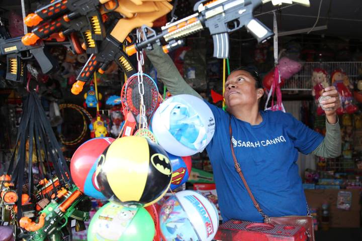 Irene Flores, owner of Factory Toys, prepares for business at the Broadacres Marketplace in Nor ...