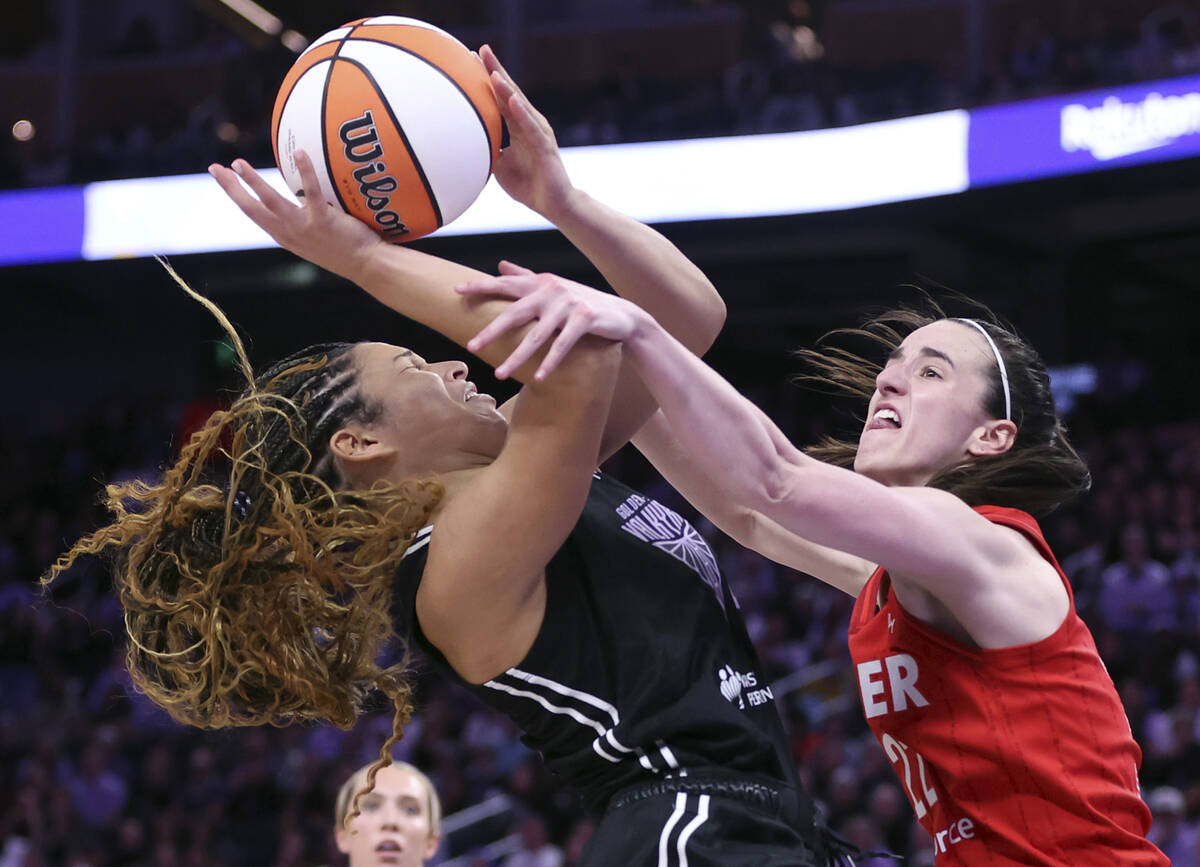 Golden State Valkyries' Veronica Burton is fouled by Indiana Fever's Caitlin Clark during the f ...