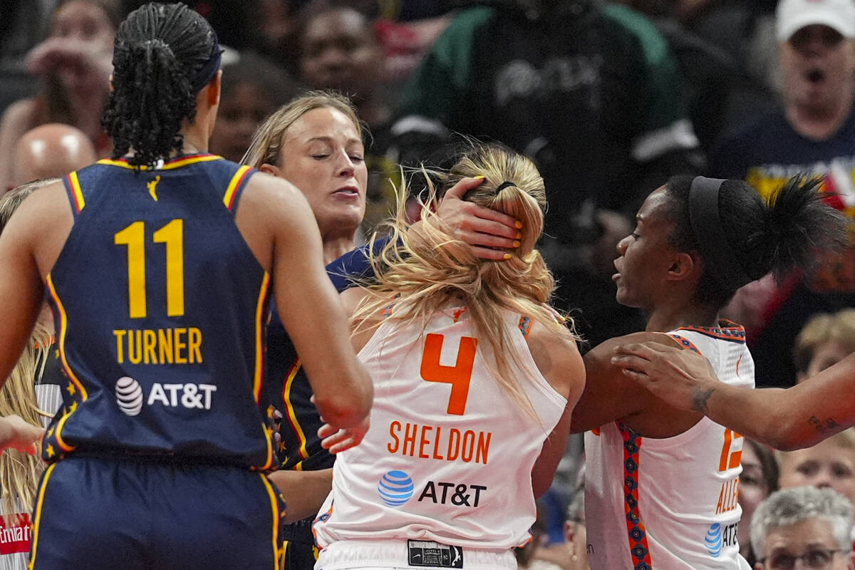 Indiana Fever guard Sophie Cunningham (8) and Connecticut Sun guard Jacy Sheldon (4) scuffle in ...