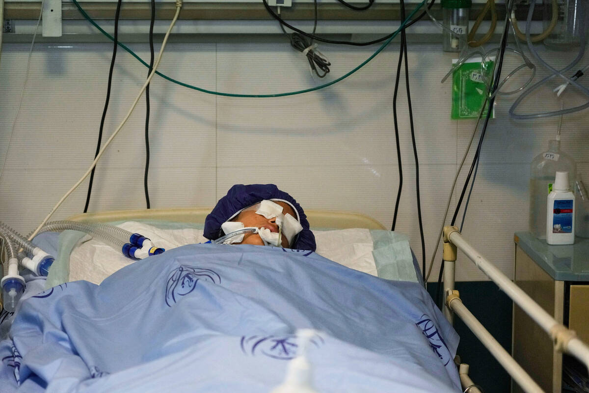 Parnia Rahmanian, 13, lies unconscious in a hospital bed following Israeli strike that targeted ...