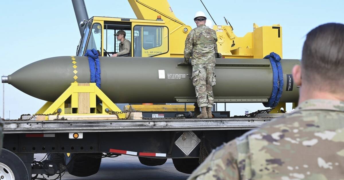 FILE - In this photo released by the U.S. Air Force on May 2, 2023, airmen look at a GBU-57, or ...