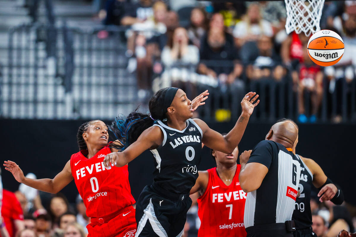 Aces guard Jackie Young (0) leaps up for the ball during a WNBA basketball game between the Ace ...