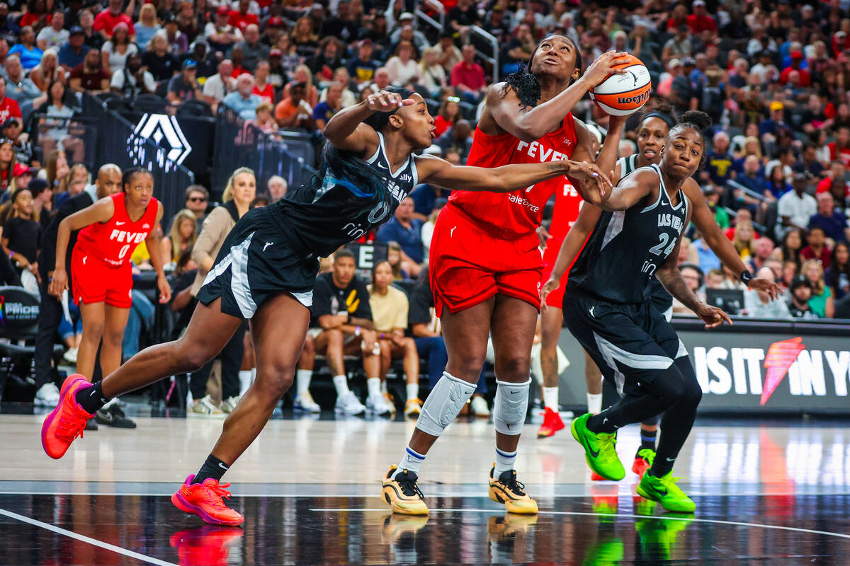 Indiana Fever forward Aliyah Boston (7) eyes the basket as Aces defense gets on her during a WN ...