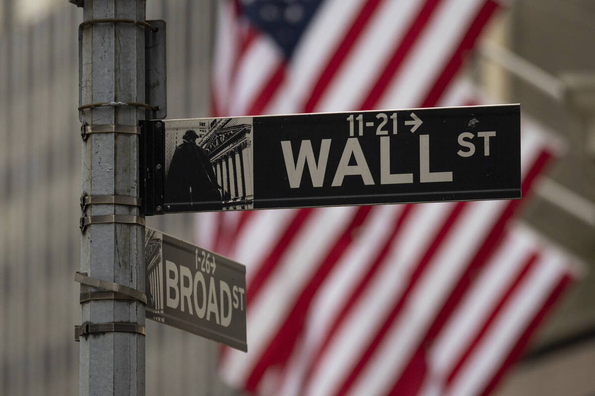 A Wall Street sign hangs near to the New York Stock Exchange, Wednesday, June 18, 2025, in New ...