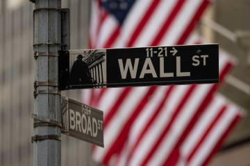 A Wall Street sign hangs near to the New York Stock Exchange, Wednesday, June 18, 2025, in New ...