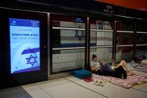 People take shelter in an underground metro station as a precaution against possible Iran missi ...