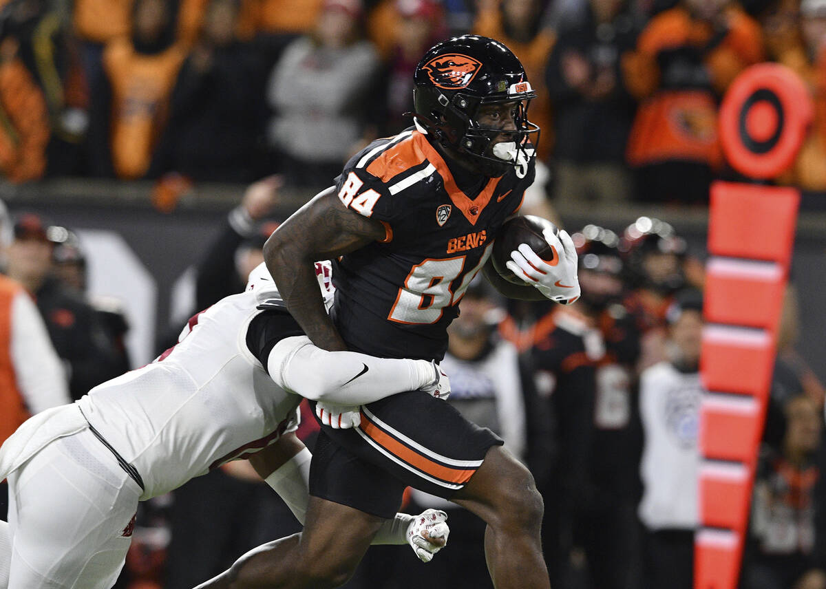 Oregon State tight end Jermaine Terry II (84) pulls Washington State defensive back Kapena Gush ...
